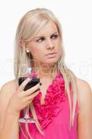 Blonde holding a glass of red wine