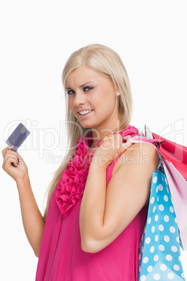 Blonde holding shopping bags and a card