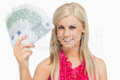 Fair hair woman holding 100 euros banknotes
