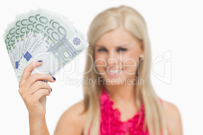 Beautiful blonde showing 100 euros banknotes