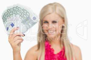 Beautiful blonde showing 100 euros banknotes