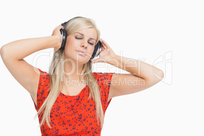 Blonde in orange dress enjoying music