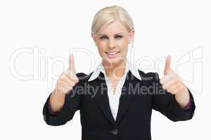 Smiling blonde businesswoman thumbs-up