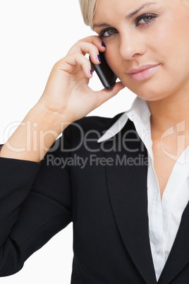 Close-up of a green eyed businesswoman using her mobile