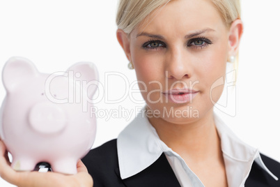 Beautiful businesswoman holding a piggy-bank