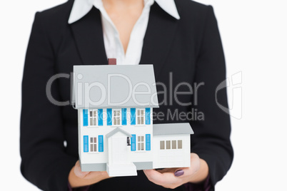 Real estate agent holding a model house