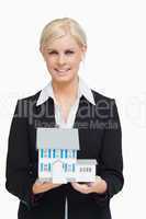 Smiling real estate agent holding a model house