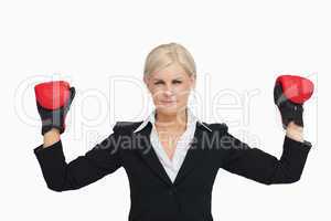 Serious businesswoman with red gloves arms raised