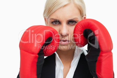 Serious blonde woman with red gloves fighting