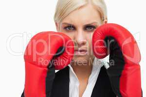 Serious blonde woman with red gloves fighting