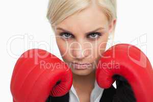 Serious green eyed woman with red gloves fighting