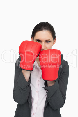 Combative brunette wearing red gloves