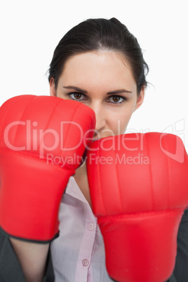 Serious brunette wearing red gloves