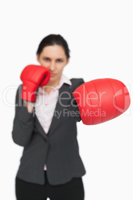Brunette wearing red gloves punching