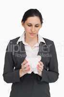 Brunette businesswoman holding a piggy-bank