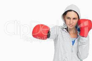 Brunette woman in sweatshirt boxing