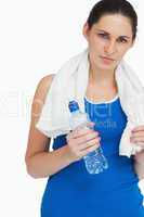 Sportswoman with a towel and a bottle
