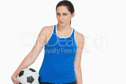 Serious sportswoman with a soccer ball