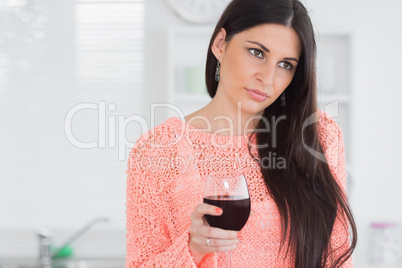 Sad woman holding glass of wine