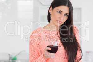Sad woman holding glass of wine