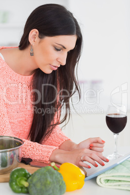 Brunette using a tablet computer