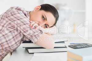 Woman leaning her head on books