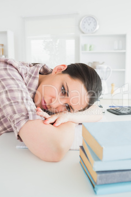 Woman leaning on table while looking away