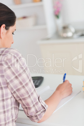 Woman writing on notepad