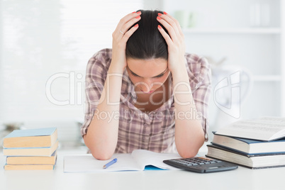 Upset woman holding her head on her hands