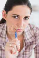 Close up of a woman thinking while looking at camera