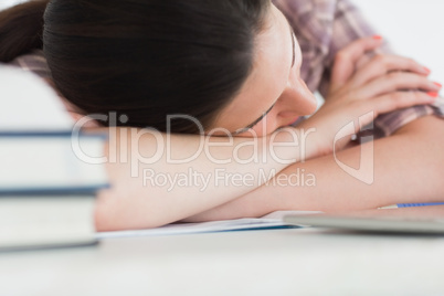 Woman leaning on the table next to books