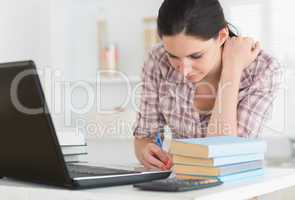 Woman working next to a computer