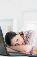 Woman resting on table before laptop