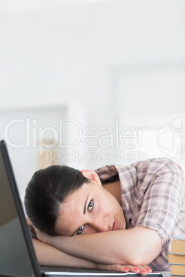 Woman leaning on table with laptop