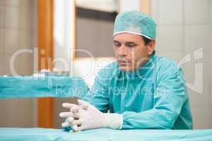 Thoughtful surgeon in a hospital