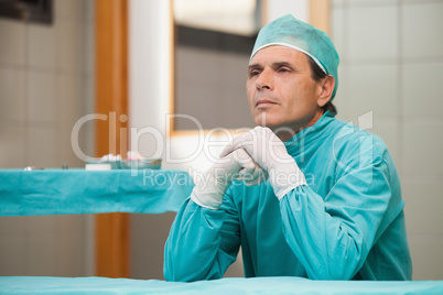 Surgeon sitting in a operation theater