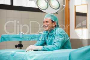 Happy surgeon sitting in operating theatre