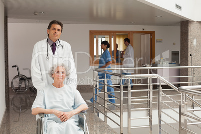 Doctor pushing woman in a wheelchair