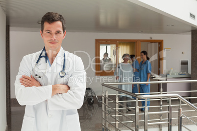 Smiling doctor standing in the hallway
