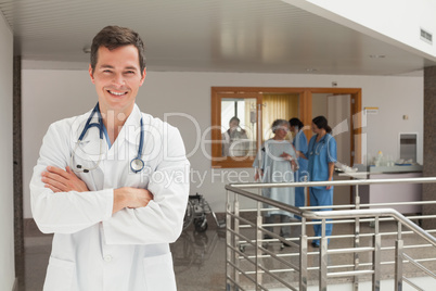 Laughing doctor standing in the hall