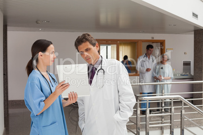 Two doctors standing in the hall
