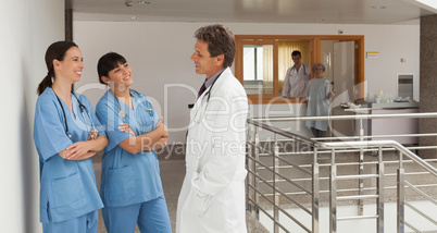 Doctor and two nurses discoursing in a hospital