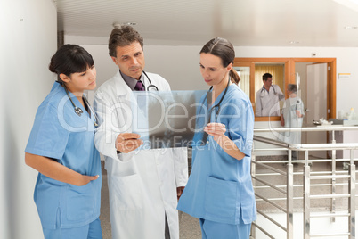 Three doctors looking at a xray