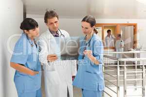 Three doctors looking at a xray