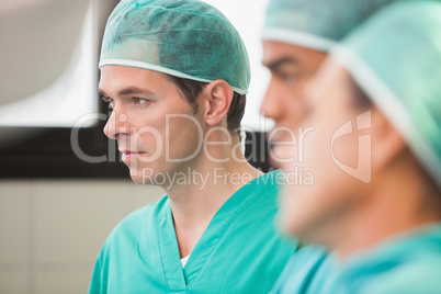 Three surgeons in operating theatre