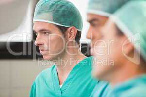 Three surgeons in operating theatre