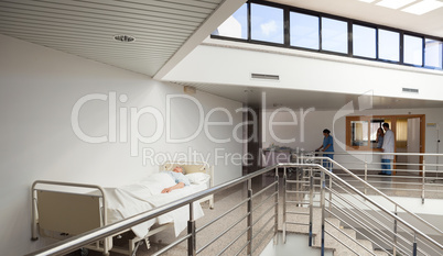 Patient lying in bed in corridor