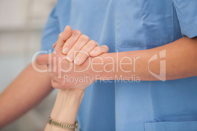Nurse holding hands of the elderly lady