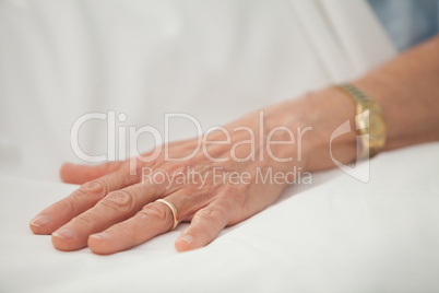 Hand of old woman with golden jewellery
