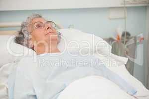 Old woman lying in hospital bed